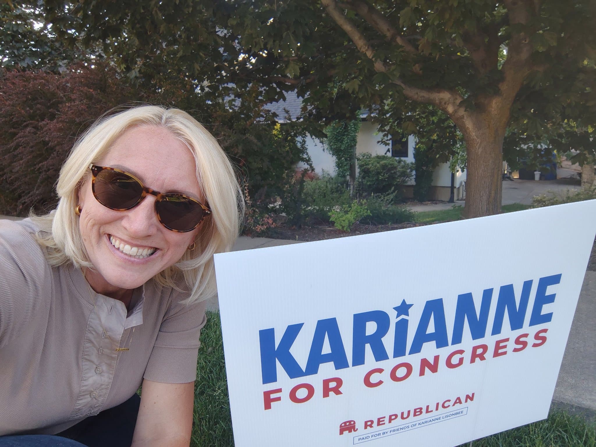 Karianne Lisonbee smiling and talking with grassroots campaign volunteers while knocking doors in Utah.