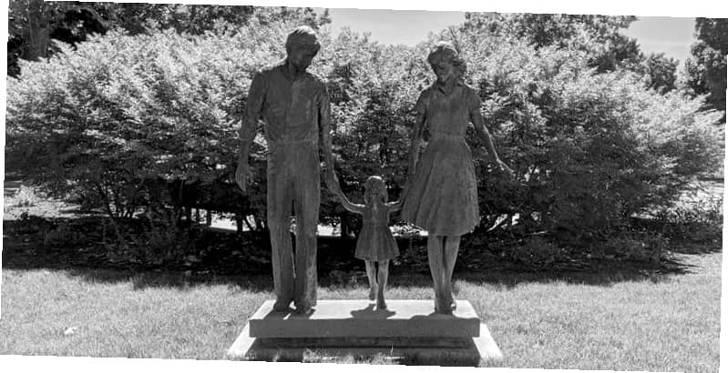 A happy multi-generational family walking together in a sunny park, symbolizing unity and strength.